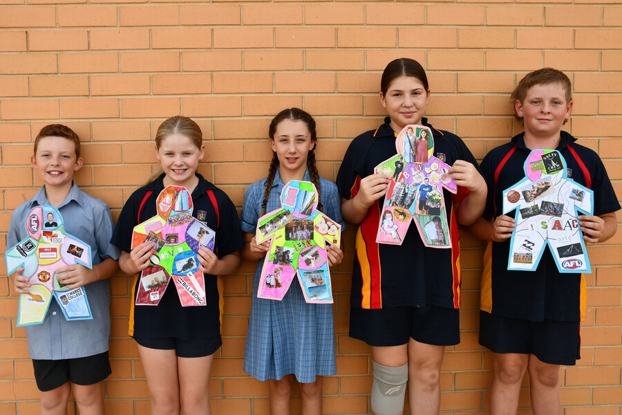 ART > Year 6 students with their 'All About Me' artwork.