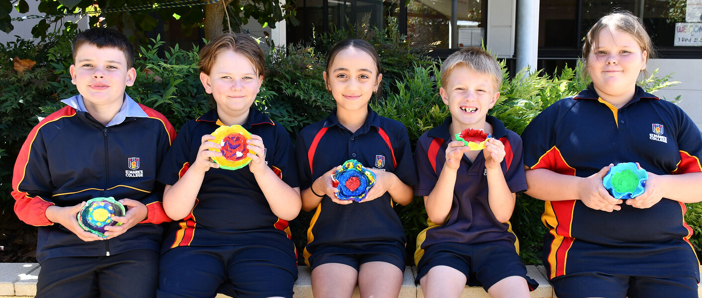 INDIGENOUS CONNECTION > Year 4 students with their painted bowls. I painted my bowl green and yellow for Australia, blue for water, red because it is on the indigenous flag and purple because it’s my favourite colour. "I used the meeting place symbol because I like when people are with me,"- Estella.
