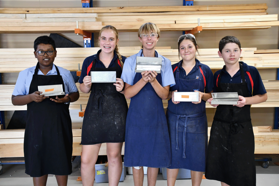 TECH > Year 8 students making sheet metal containers.