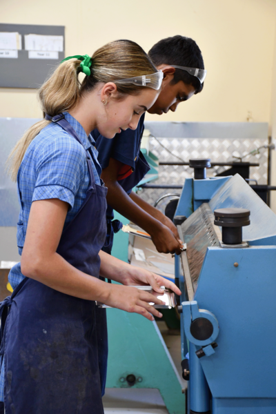TECH > Year 7 students making sheet metal containers.