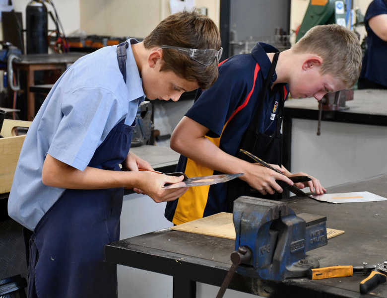 TECH > Year 7 students making sheet metal containers.