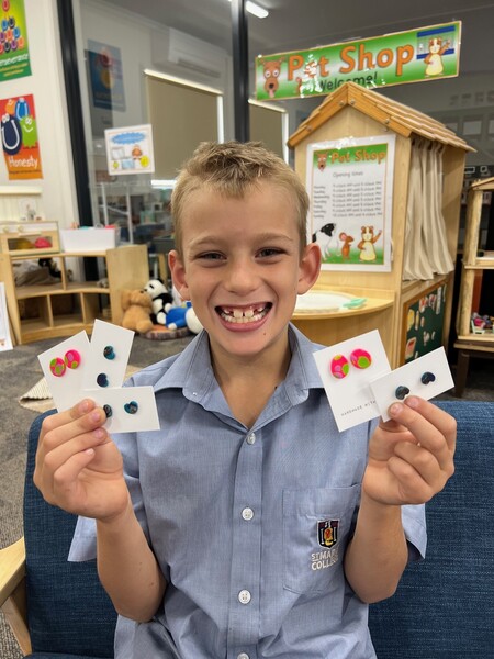 CHILDREN'S UNI > Leo was proud of the earrings he made!